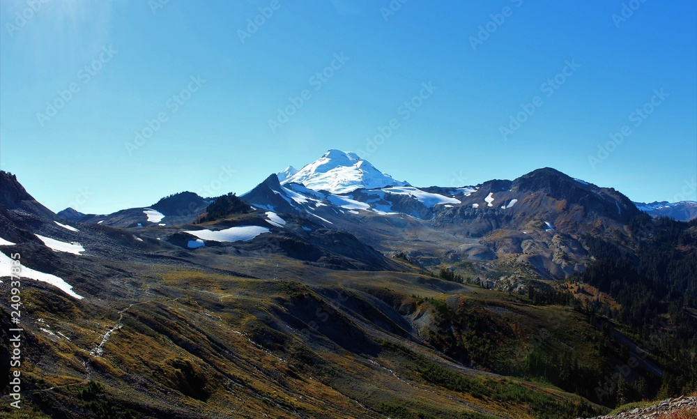 A panoramic view of an active volcano, Mount Baker and Ptarmigan Ridge in the North Cascades