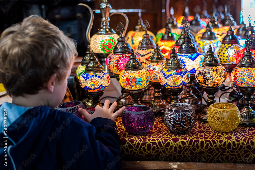 Child looking at typical Turkish table lamps