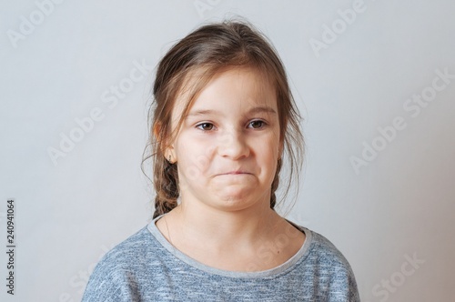 Little girl with pigtails expresses emotions of negative anger and irritation