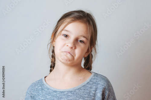 Little girl with pigtails expresses emotions of negative anger and irritation