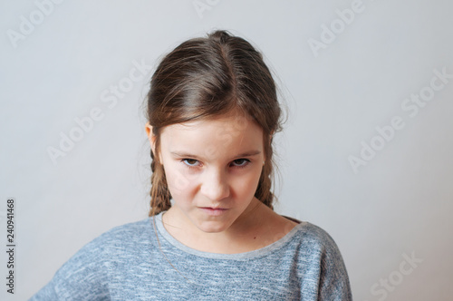 Little girl with pigtails expresses emotions of negative anger and irritation