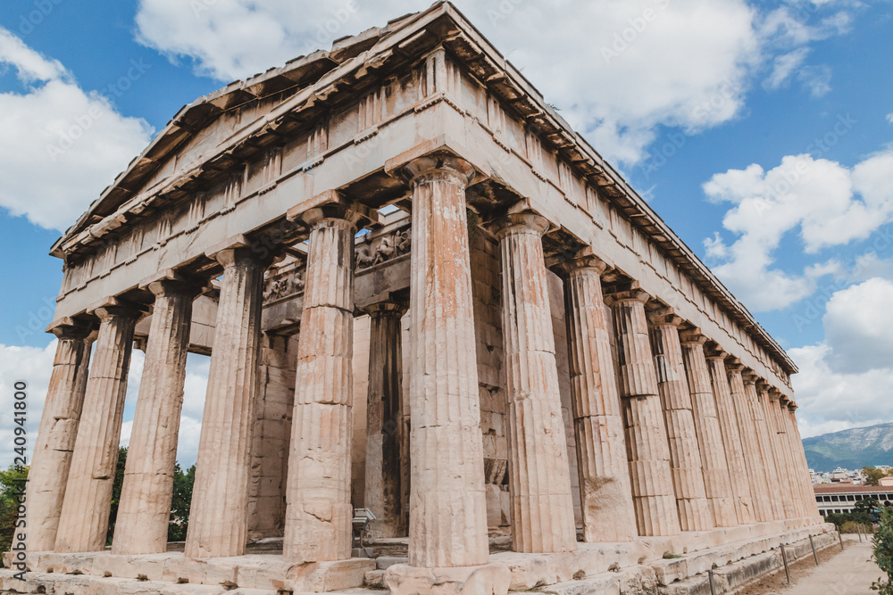 Temple of Hephaestus in Agora close-up, Athens, Greece. It is one of the main landmarks of Athens. Front view of the ancient Greek Temple of Hephaestus in summer. Historical sunny postcard of Athens.