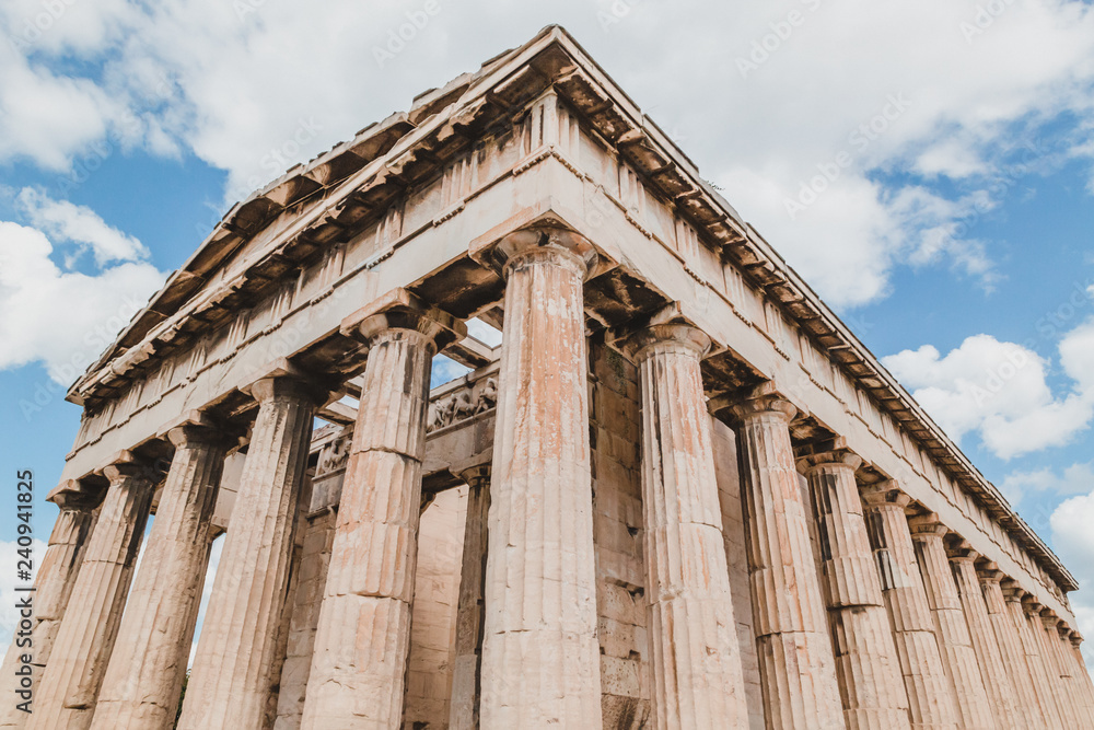 Temple of Hephaestus in Agora close-up, Athens, Greece. It is one of the main landmarks of Athens. Front view of the ancient Greek Temple of Hephaestus in summer. Historical sunny postcard of Athens.