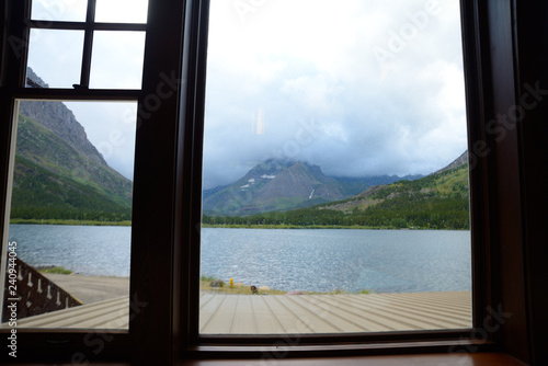 Looking through a window frame at a clear blue lake in Glacier National Park. © bettys4240
