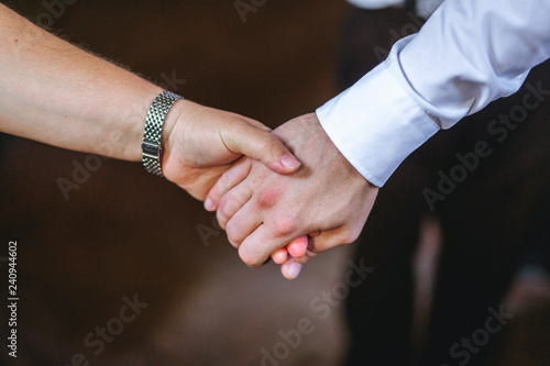 man and woman holding hands closeup