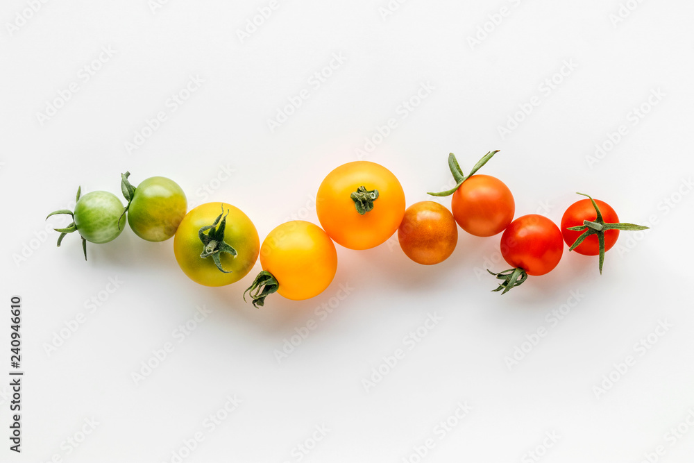Colorful organic cherry tomatoes on a white background, Holland cherry tomato - obrazy, fototapety, plakaty 