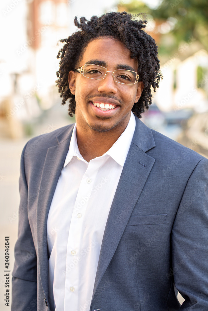 Young handsome African American man smiling outside. Young handsome African American man smiling outside.