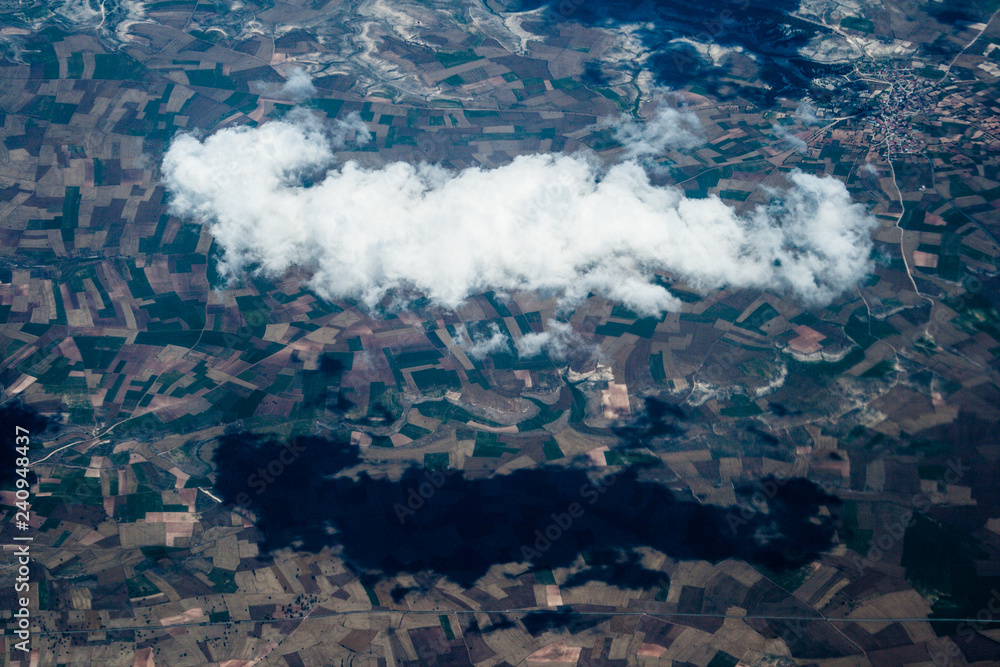 Mountain aerial view. houses and fields. clouds