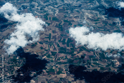 Canvas Print Mountain aerial view. houses and fields. clouds