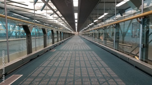 Long straight walkway in airport terminal