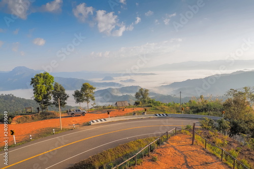 curve high way with mountain and sea of mist background, Tham Sakoen View Point attraction on route 1148 Phayao-Nan, Tham Sakown National Park, Nan Province, northern of Thailand.