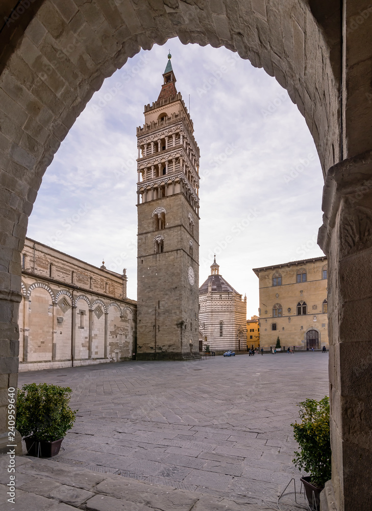 Beautiful view of the Piazza del Duomo in Pistoia framed by an arch of the Palazzo del Comune, Tuscany, Italy