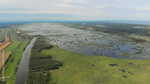 Aerial view of a lake that is next to a sea photo