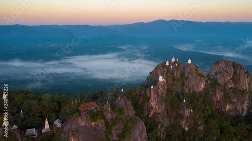 Motion timelapse hyperlapse  of Fly up over Temple at The cliff on top of Mounain, wat chaloem phra kiat lampang Chiang mai, north of Thailand