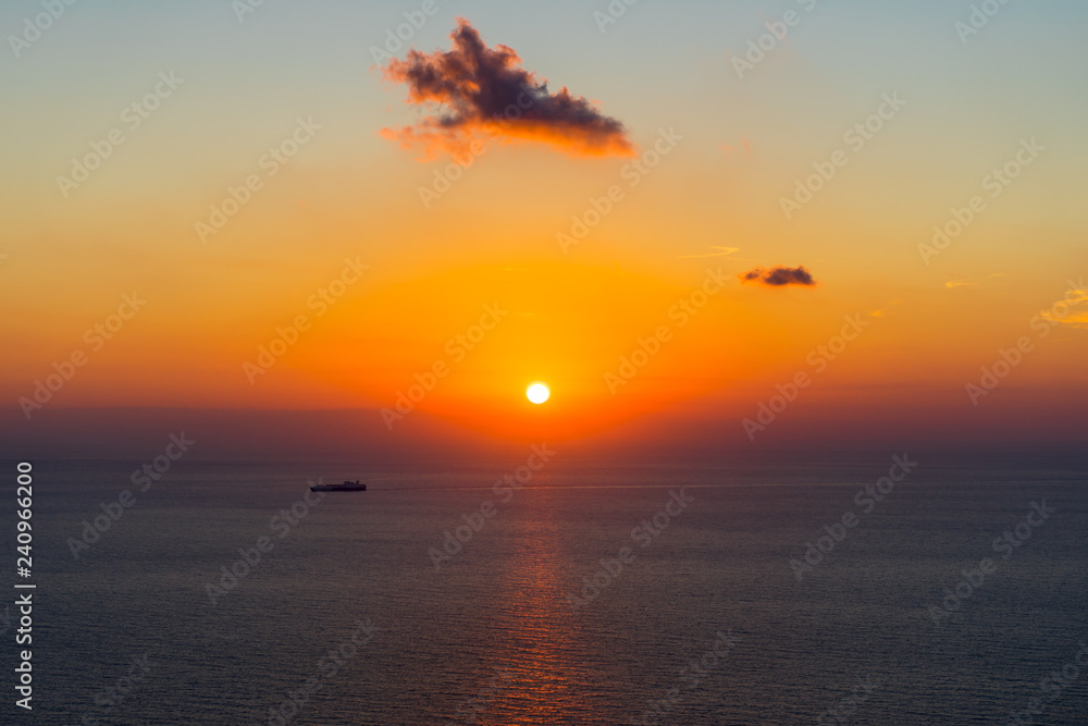 Greece, Zakynthos, Red sunset sky reflecting on silent ocean water of ionian sea