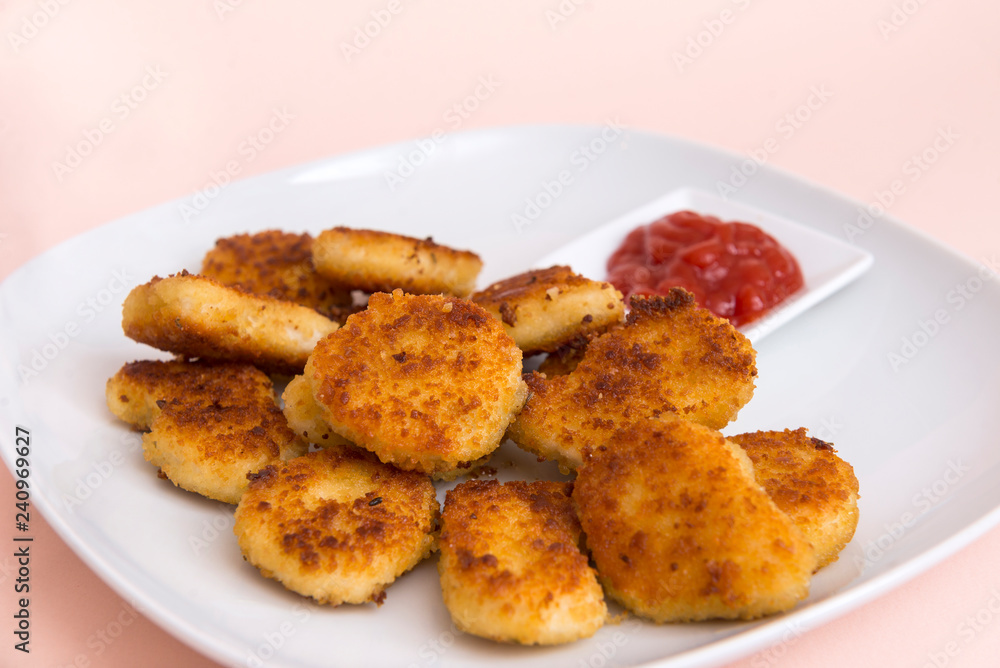 chicken nuggets with ketchup on a white plate chicken nuggets with ketchup on a white plate