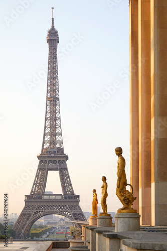 Eiffel tower and Trocadero golden statues, clear summer sunrise in Paris, France © andersphoto