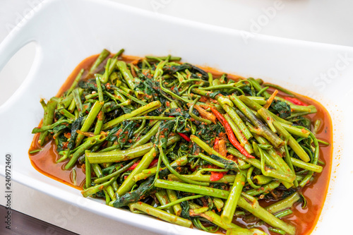 Indonesian food tumis kangkong terasi or stir fry swamp cabbage photo