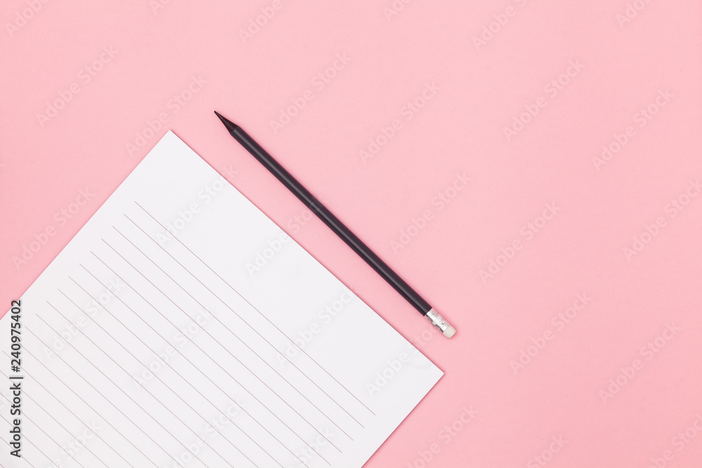 Blank page in a line with black pencil. Plans and goals for the year. Freelancer workplace concept. Top view with copy space for input the text. Flat lay, colored pink background. Blank page in a line with black pencil. Plans and goals for the year. Freelancer workplace concept. Top view with copy space for input the text. Flat lay, colored pink background.