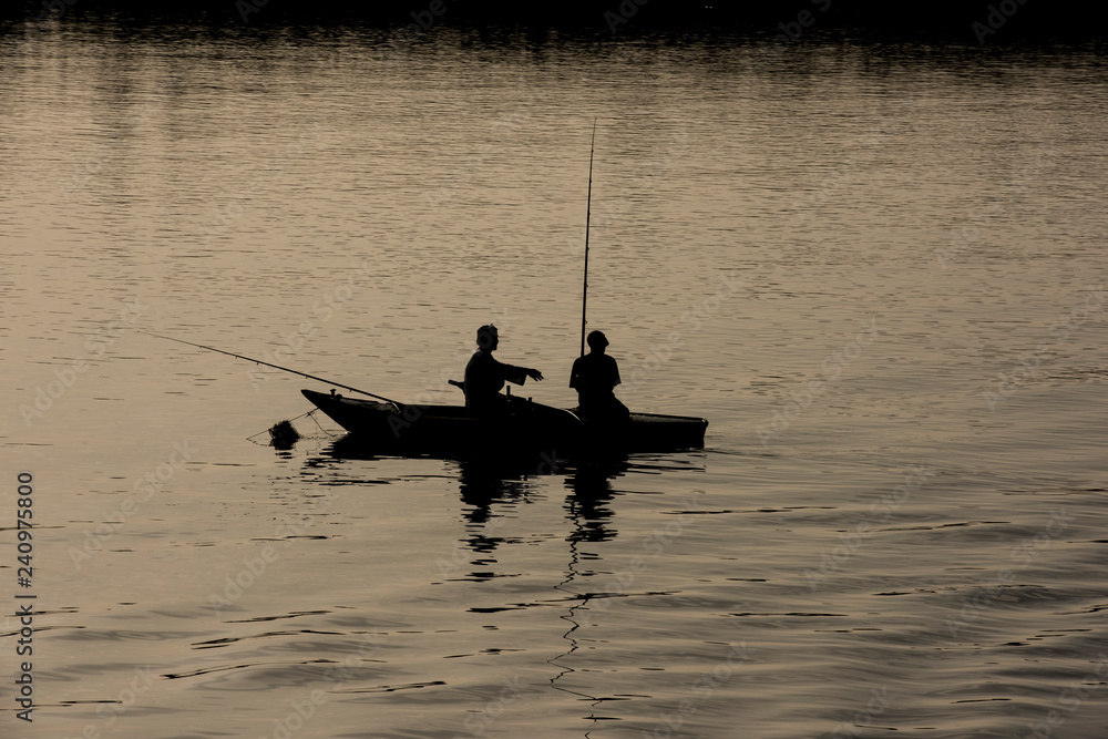 Traditional egyptian bedouin fisherman in silhouette on nile river