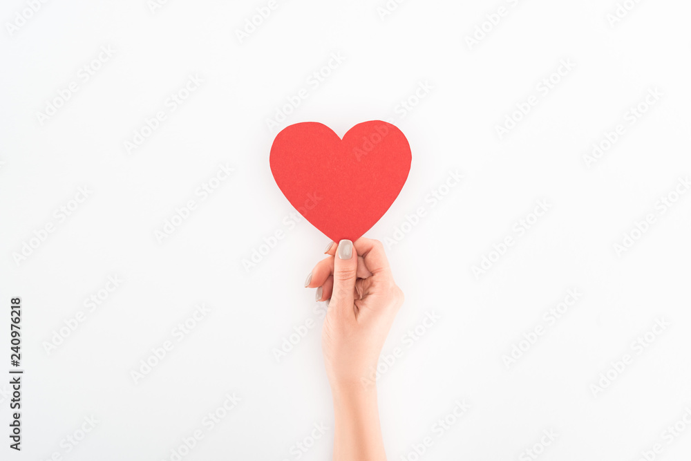 partial view of woman holding red heart symbol isolated on white, st valentine day concept partial view of woman holding red heart symbol isolated on white, st valentine day concept