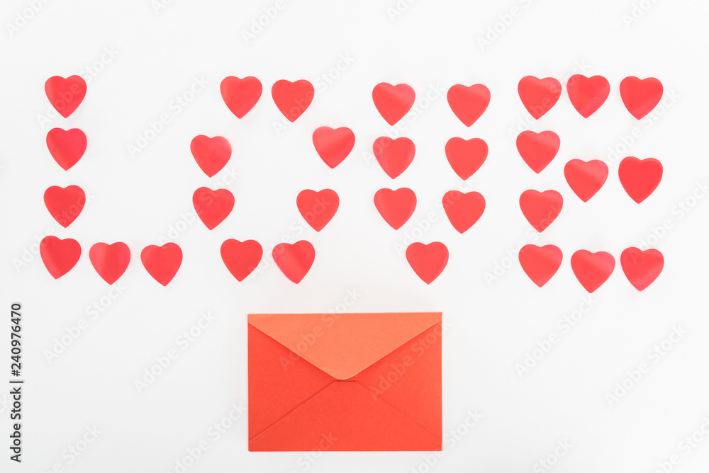 top view of envelope and lettering love made of heart symbols isolated on white, st valentine day concept top view of envelope and lettering love made of heart symbols isolated on white, st valentine day concept