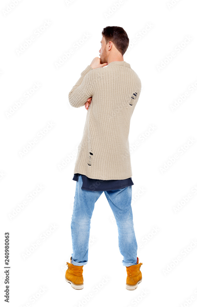 Back view of a pensive man in a knitted sweater. Back view of a pensive man in a knitted sweater.