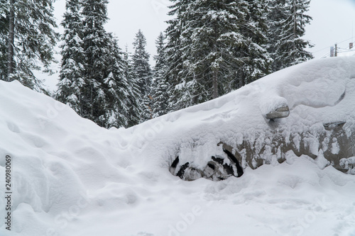 the machine is covered with snow blizzard. bad weather. a lot of snow.