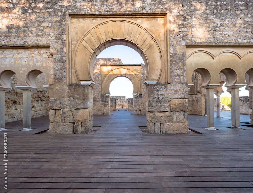 Arab arches in the ruins of Medina Azahara in Cordoba, Spain at sunset.