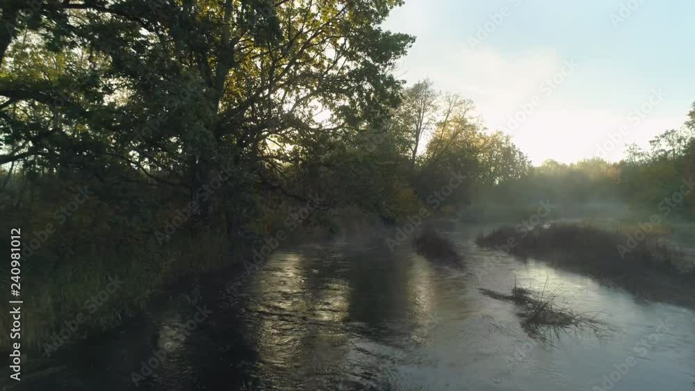 Flying low over river in early morning during sunrise Flying low over river in early morning during sunrise