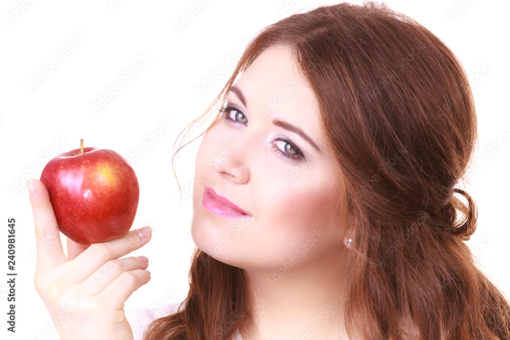 Woman holding apple fruit close to face Woman holding apple fruit close to face