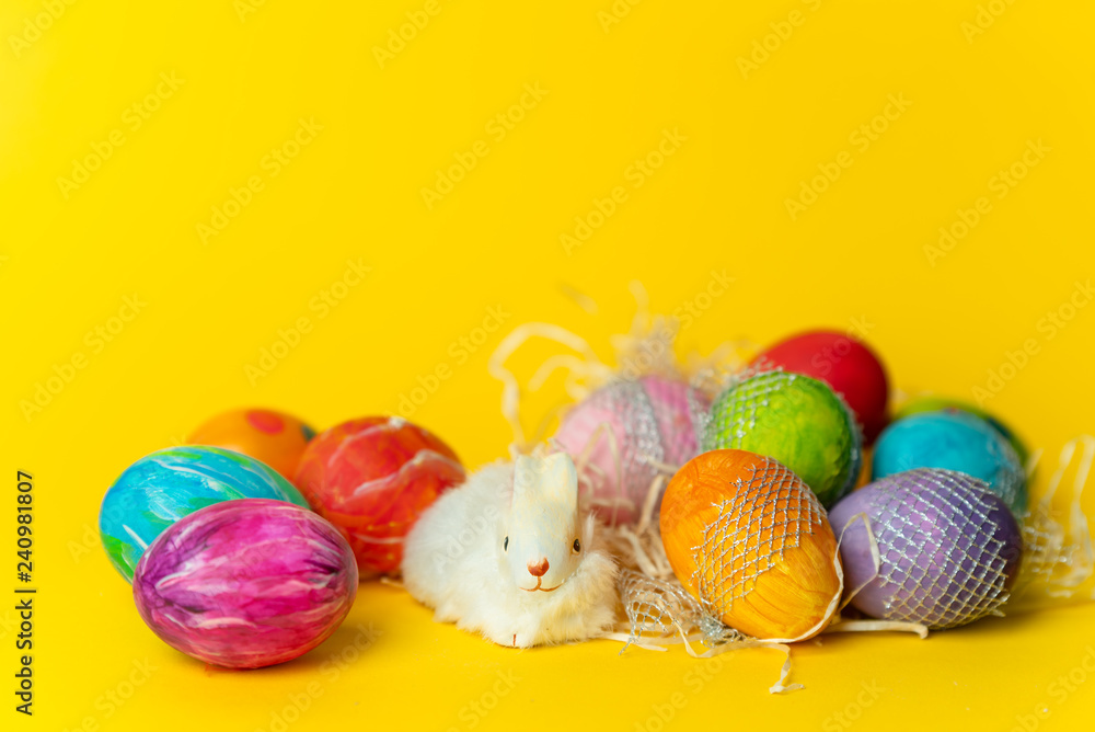 colorful, hand-painted, pastel Easter eggs on a bright, yellow, spring background colorful, hand-painted, pastel Easter eggs on a bright, yellow, spring background