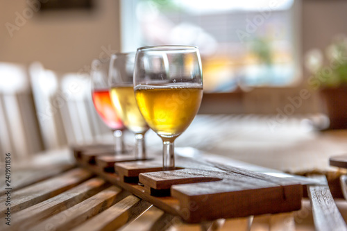 Three glasses of Cider in a wood table in Norway