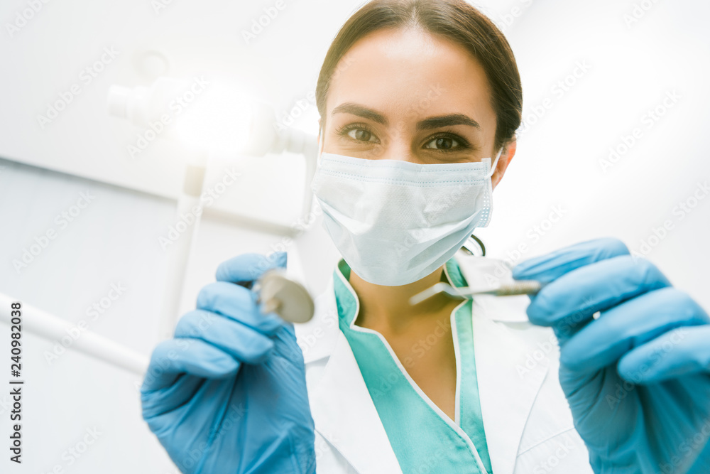 selective focus of female stomatologist holding instuments in hands selective focus of female stomatologist holding instuments in hands
