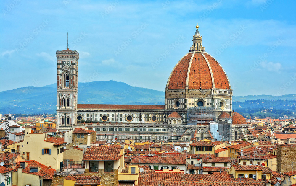 Aerial view of Duomo Florence Cathedral and buildings in the old city. The medieval Cathedral with iconic red dome is the third largest church in the world. Panoramic skyline. Italy, Florence