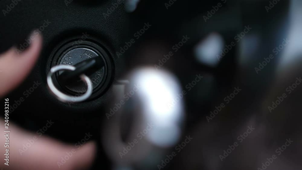 Close-up. Female hand inserts the key into the ignition, the buttons on the panel light up 4K Slow Mo Close-up. Female hand inserts the key into the ignition, the buttons on the panel light up 4K Slow Mo
