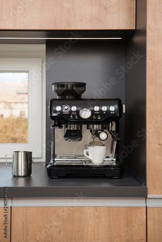 White cup of espresso in coffee machine