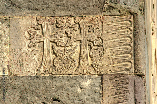 Corner of the wall with carved crosses and patterns on the wall of the Church in Geghard monastery of Armenia
