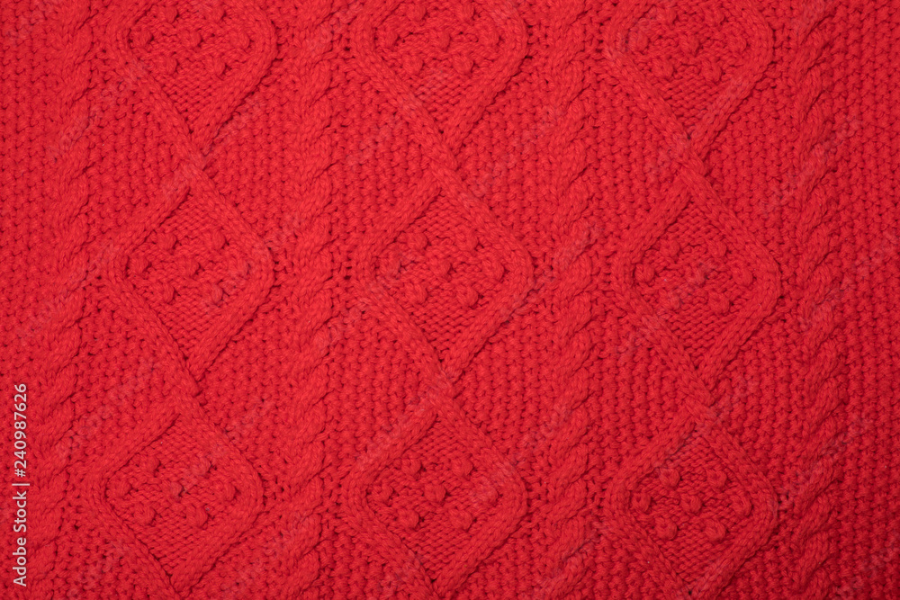 red knitted texture with a pattern.