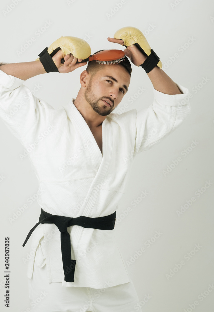 Male hairstyle. Athlete in kimono and gloves combs his hair. Fighter and handsome. Bravery and delicate together. Manly and well-groomed man Stock Photo | Adobe Stock Male hairstyle. Athlete in kimono and gloves combs his hair. Fighter and handsome. Bravery and delicate together. Manly and well-groomed man Stock Photo | Adobe Stock