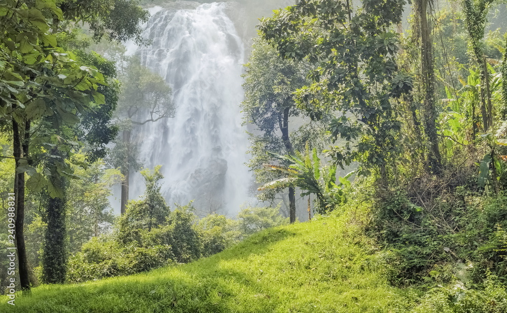 Khlong Lan Waterfall, Beautiful waterfalls flowing from the chill around with green forest background in khlong Lan national park, Kamphaeng Phet, Thailand. 