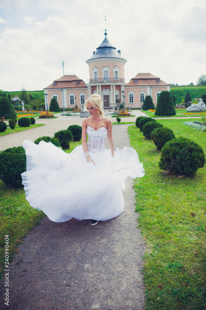 Beautiful blonde princess bride posing near old medieval castle Beautiful blonde princess bride posing near old medieval castle
