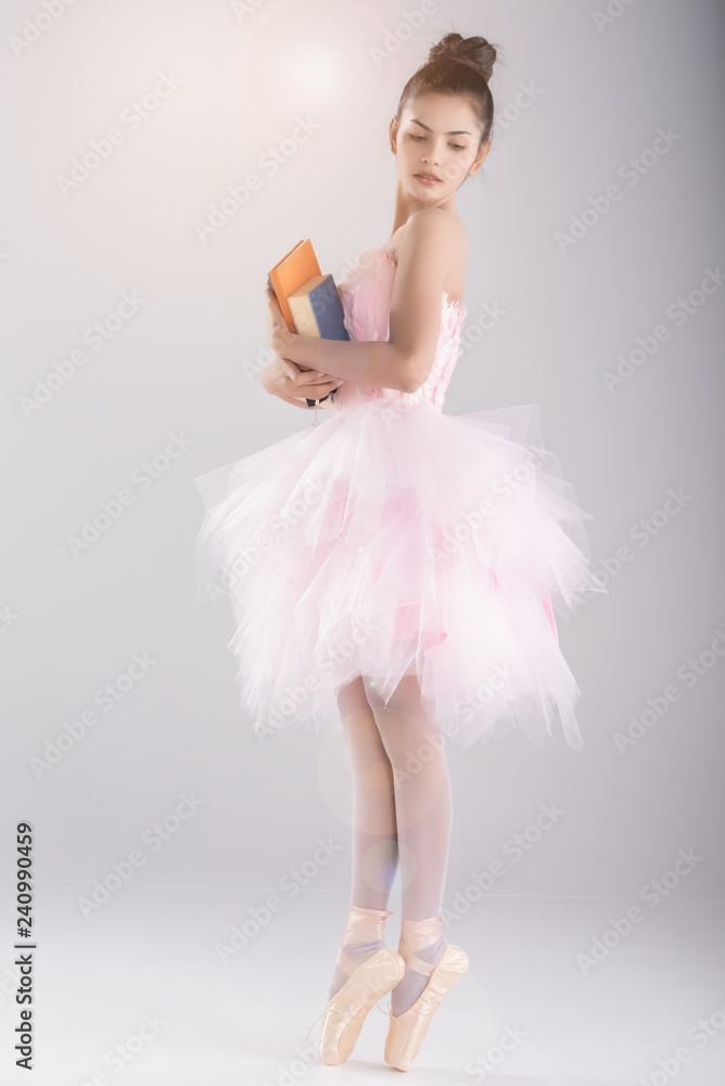 Emotion work is dance.Happy business,education woman in ballet dance style.stand on floor,hand hold colorful thick book. Emotion work is dance.Happy business,education woman in ballet dance style.stand on floor,hand hold colorful thick book.