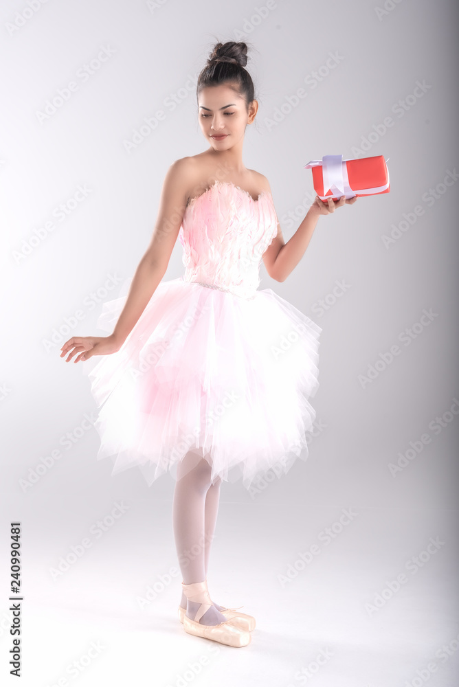 Beautiful young woman ballerina hold gife in hand for somebody special or  in christmas and happy new year,show ballet dance,dress in pink  feather,professional outfit,Beauty of classic ballet. Stock Photo | Adobe  Stock