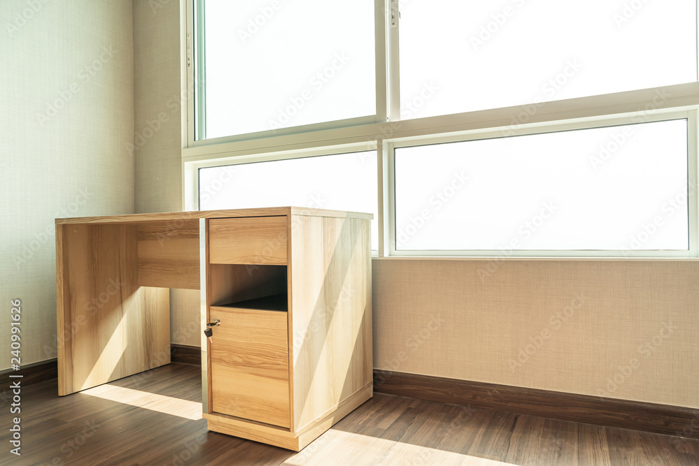empty working table in room with window empty working table in room with window