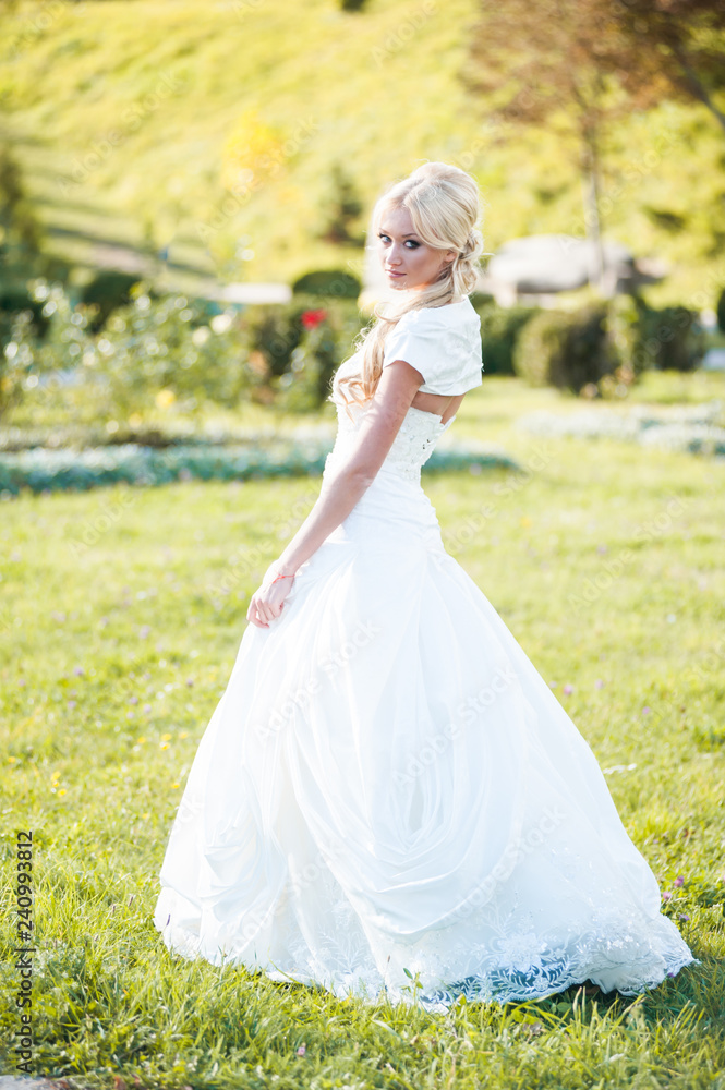 Beautiful blonde bride in fashion white wedding dress Beautiful blonde bride in fashion white wedding dress