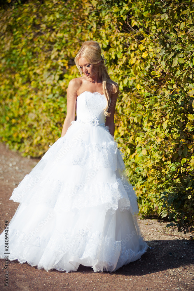 Beautiful blonde bride in fashion white wedding dress