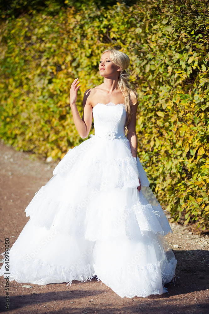 Beautiful blonde bride in fashion white wedding dress