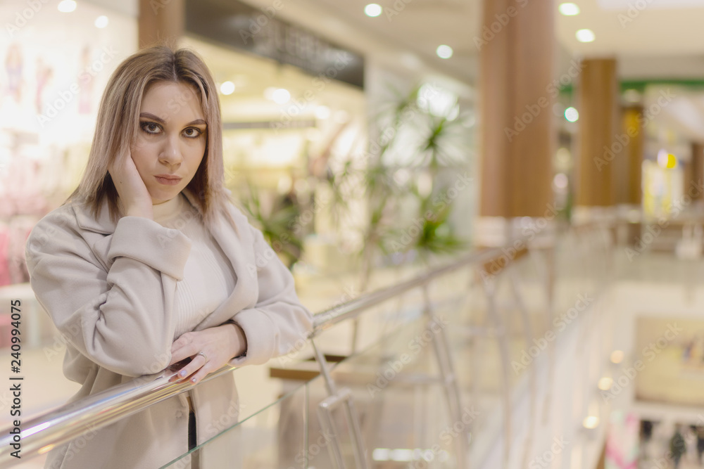 girl walking through the Mall . Full length of atractive young business woman in white shirt and suspenders looking away and keeping hands in pockets while walking through the city center near shoping girl walking through the Mall . Full length of atractive young business woman in white shirt and suspenders looking away and keeping hands in pockets while walking through the city center near shoping