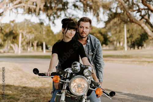 Precious Cute Leisure Lifestyle Portrait of Handsome Guy and Girl Beauty Being Silly Fun and Laughing while Riding Classic Motorcycle Bike While in Love